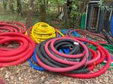 many different colored hoses laying on the ground