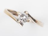 a close up of a diamond ring on a white surface