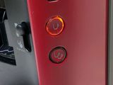 a close up of a red coffee maker with buttons on it