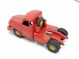 a red toy truck that is sitting on a white surface