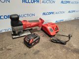 a red corded sander and two other tools on a table