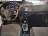 a dashboard of a small car with a clock and steering wheel