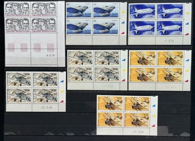several stamps of different sizes and colors are displayed on a black surface