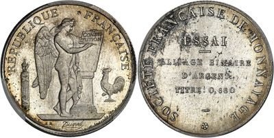 a silver coin with a statue on top of it