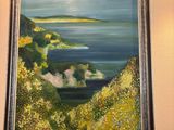 painting of a painting of a view of the ocean in a frame