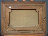 an old wooden easel with a picture hanging on it