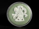 a close up of a ring on a black surface with a picture of a man riding a horse