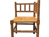 an image of a wooden chair with a woven seat on a white background