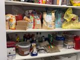 a pantry full of food and condiments on the shelves