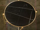 marble top side table with brass legs and a black marble top