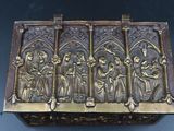 an image of a brass box with a group of people on it