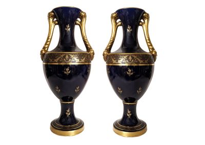 two blue vases with gold decoration on them