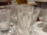many glasses sitting on a table in a room