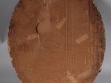 a brown plate on a table with a white background