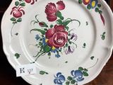 a plate with flowers on it sitting on a table