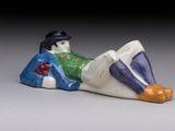 a figurine of a man laying down on the ground