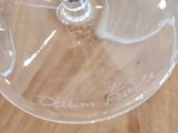 several empty wine glasses sitting on top of a wooden table