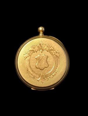 a close up of a gold coin on a black background