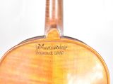 a close up of a violin that is on a table