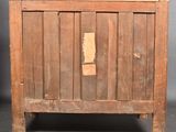 an old wooden cabinet with a hole in the door