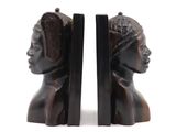 pair of bookends in the shape of a woman ' s head and a man ' s head