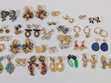 many different types of earrings on a white surface