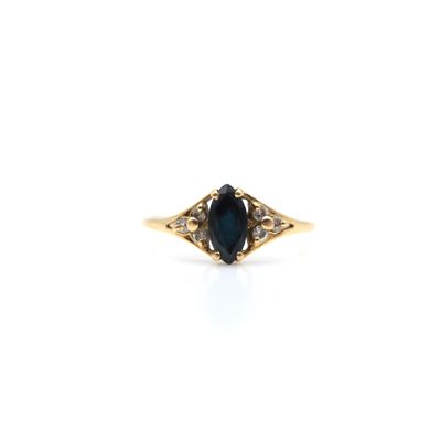 a close up of a ring with a blue stone in it