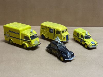 four toy cars that are sitting next to each other