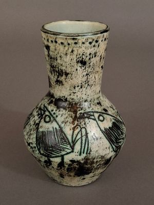 a small vase with a black and white design on it