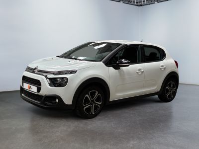 a white citrole parked in a large white room