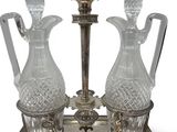 two glass vases sitting on a metal stand