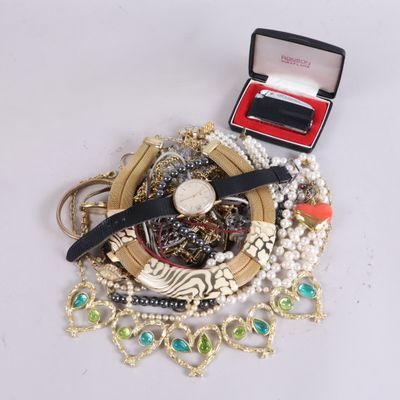 a box with a watch, bracelets, and other jewelry on it