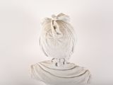 a white statue of a woman with a bow on her head