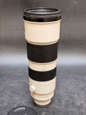 a camera lens sitting on a table next to a cup of coffee