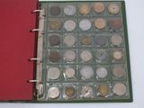 a red book with a bunch of coins inside of it