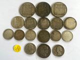several different coins are arranged in a circle on a white surface