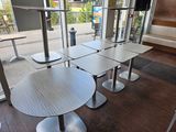 tables and chairs in a restaurant with a view of the outside