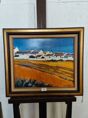 une image d'un tableau sur un chevalet dans une pièce