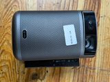 a close up of a speaker sitting on top of a wooden floor