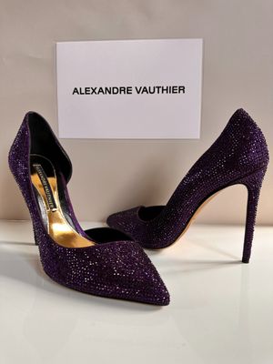 the purple shoes are on display in a display case