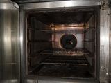 a metal oven with a door open in a kitchen