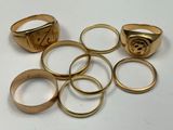 a lot of gold rings on a white table