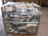 a metal cart with many items in it in a warehouse