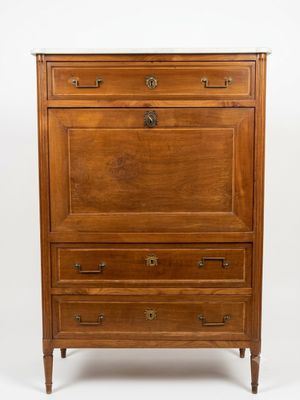 a wooden chest of drawers with a marble top