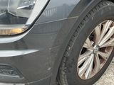 the front end of a gray volkswagen suv parked in a parking lot