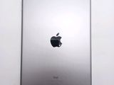an apple ipad sitting on top of a white table next to a white wall