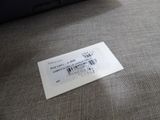 a ticket sitting on the floor next to a laptop computer