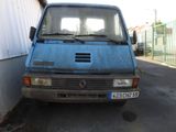 a blue van parked in a parking lot next to a building