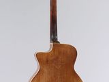 an acoustic guitar with a wooden back and neck