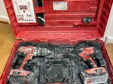 a red tool case with tools in it on the floor